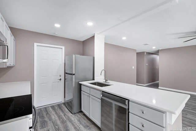 kitchen featuring dark hardwood / wood-style flooring, sink, white cabinets, and stainless steel appliances