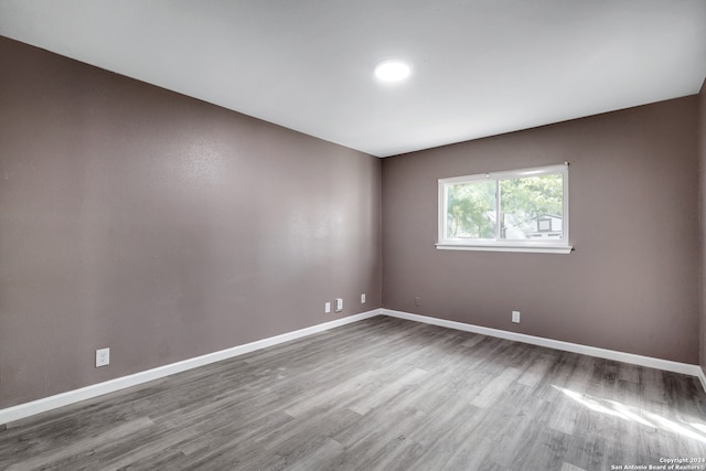 empty room with hardwood / wood-style floors