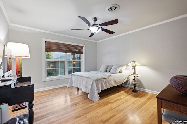 bedroom featuring ceiling fan, crown molding, and light wood-type flooring