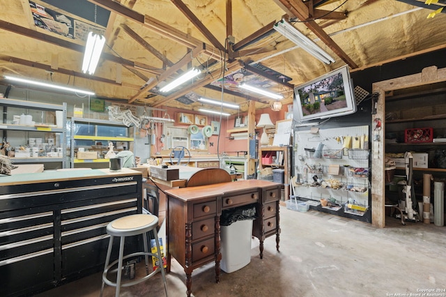 interior space with a workshop area and concrete floors