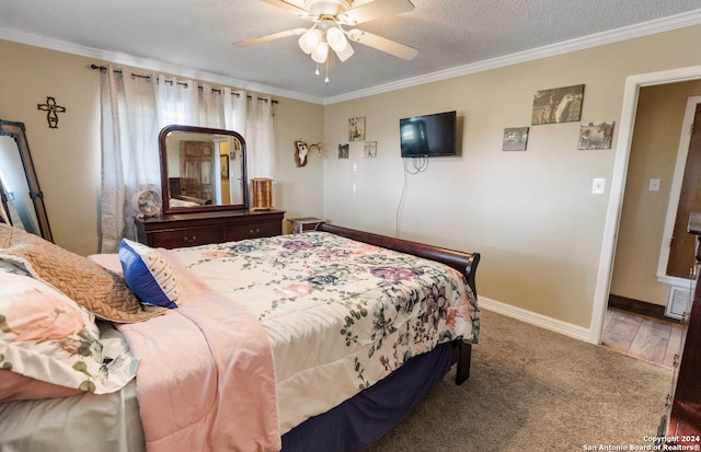 bedroom featuring hardwood / wood-style floors, ceiling fan, ornamental molding, and a textured ceiling