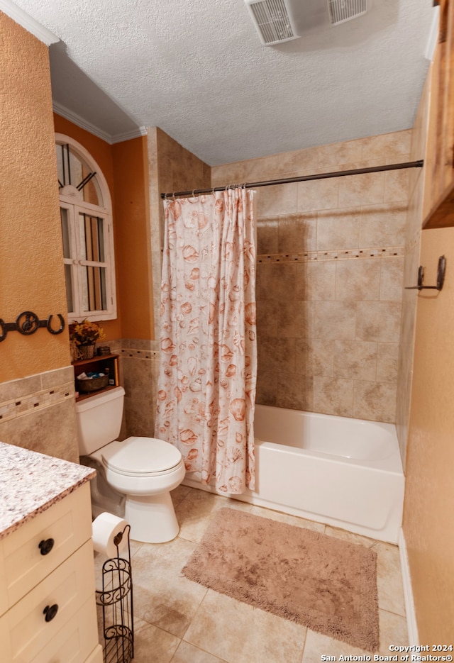 full bathroom with tile patterned flooring, a textured ceiling, toilet, vanity, and shower / tub combo