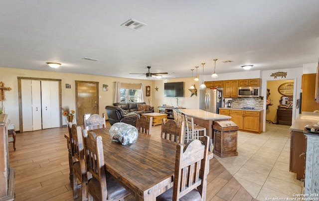 dining space with ceiling fan and light hardwood / wood-style floors