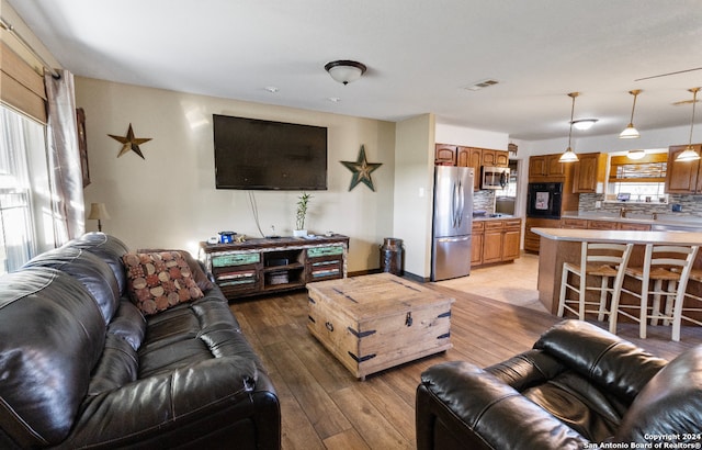 living room featuring light hardwood / wood-style floors and a wealth of natural light