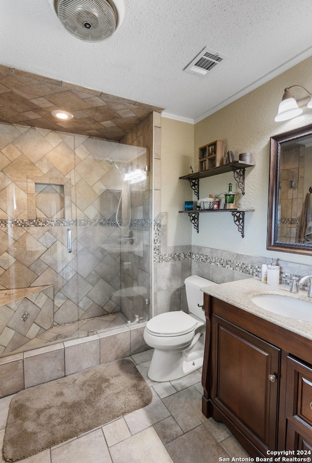 bathroom with walk in shower, tile patterned flooring, crown molding, toilet, and vanity