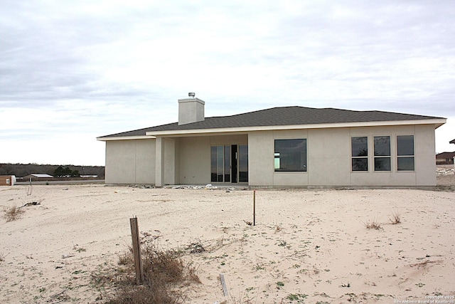 rear view of property with a chimney