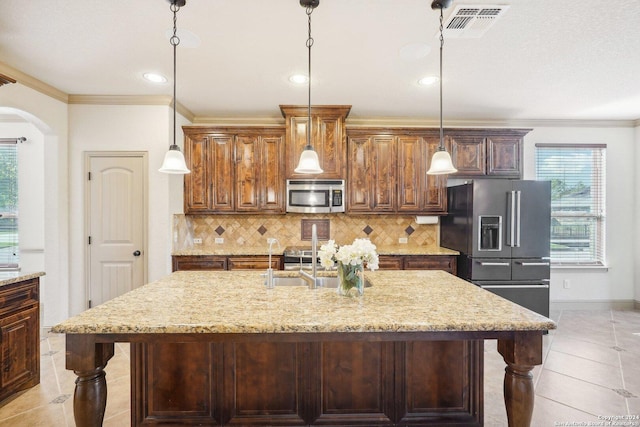 102 Santa Anita, Boerne, TX 78006 - kitchen with appliances with stainless steel finishes, arched walkways, light tile patterned floors, light stone counters, and backsplash