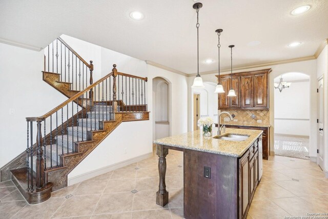 102 Santa Anita, Boerne, TX 78006 - kitchen featuring arched walkways, a sink, light tile patterned flooring, tasteful backsplash, and recessed lighting