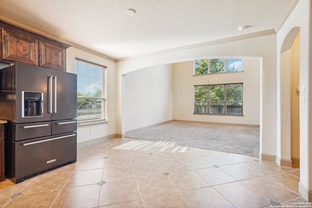 kitchen with light carpet, high end fridge, ornamental molding, dark brown cabinets, and a textured ceiling