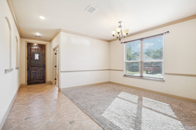 foyer entrance with light tile patterned floors, ornamental molding, and an inviting chandelier