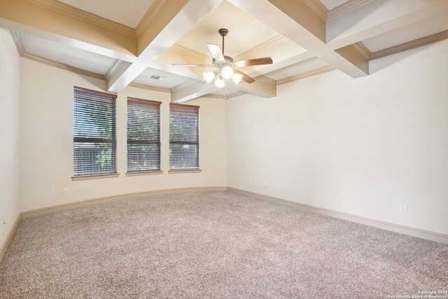 carpeted empty room with beam ceiling, crown molding, ceiling fan, and coffered ceiling