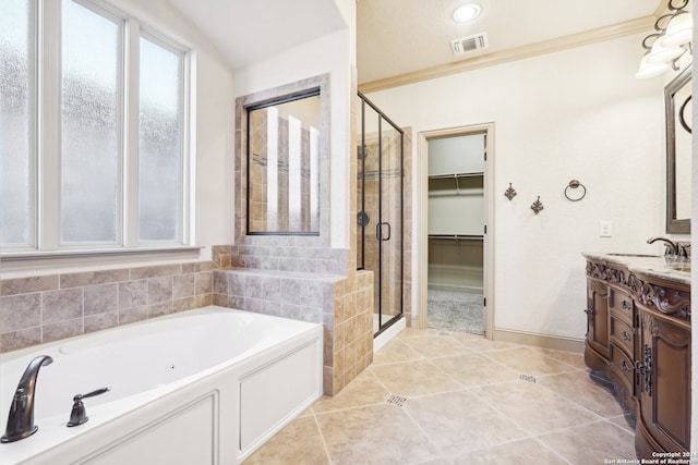 bathroom with tile patterned floors, vanity, and plus walk in shower