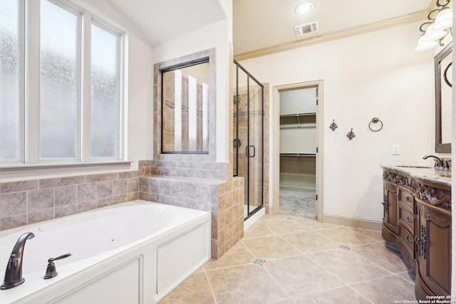 102 Santa Anita, Boerne, TX 78006 - bathroom featuring a shower stall, vanity, a tub with jets, a walk in closet, and tile patterned floors