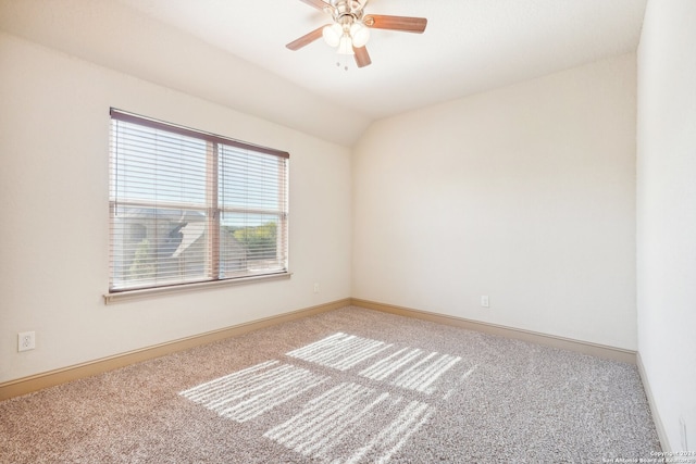 unfurnished room featuring light carpet, ceiling fan, and vaulted ceiling