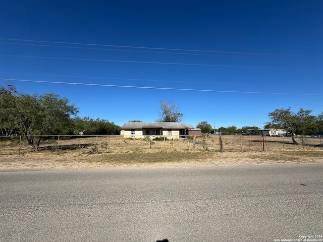 view of front of house with a rural view