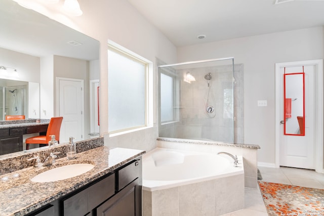 bathroom with shower with separate bathtub, vanity, and tile patterned floors