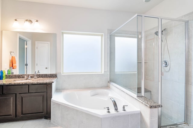 bathroom with tile patterned flooring, vanity, and separate shower and tub