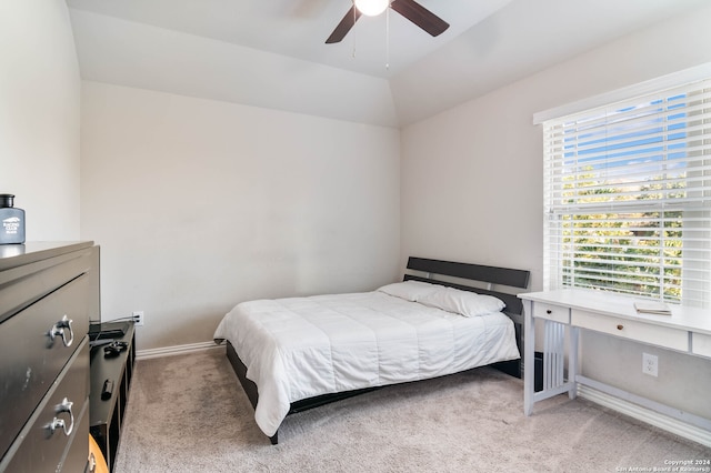 carpeted bedroom featuring vaulted ceiling, multiple windows, and ceiling fan