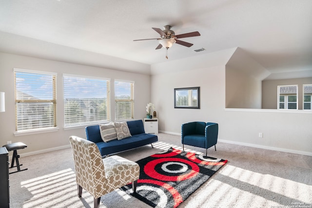 living room with ceiling fan, a healthy amount of sunlight, and light colored carpet