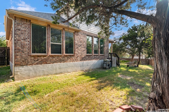 view of side of home featuring a yard