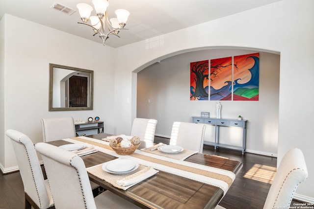 dining space featuring a notable chandelier and dark hardwood / wood-style floors