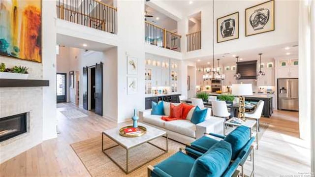 living room featuring light hardwood / wood-style floors and a high ceiling