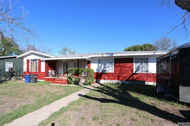 ranch-style home with a porch and a front yard