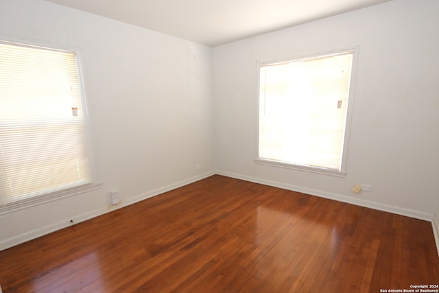 empty room featuring dark wood-type flooring