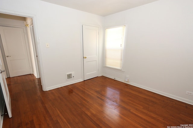 unfurnished bedroom featuring dark hardwood / wood-style floors