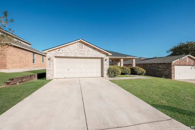 ranch-style home featuring a front lawn and a garage