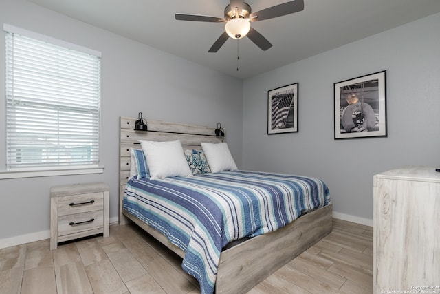 bedroom with ceiling fan and light wood-type flooring