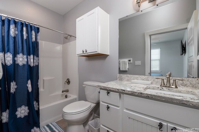 full bathroom featuring shower / bath combination with curtain, vanity, and toilet