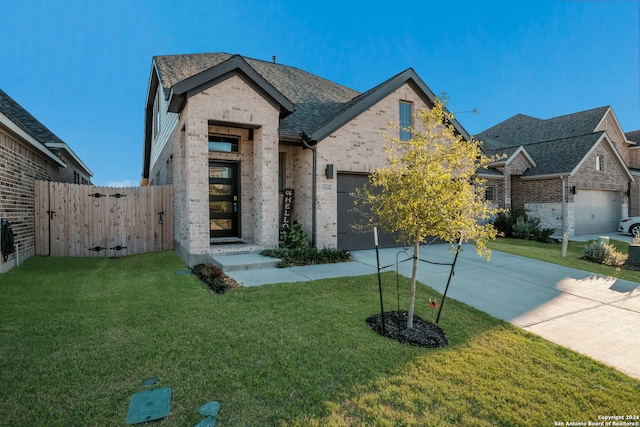 view of front facade with a front yard and a garage