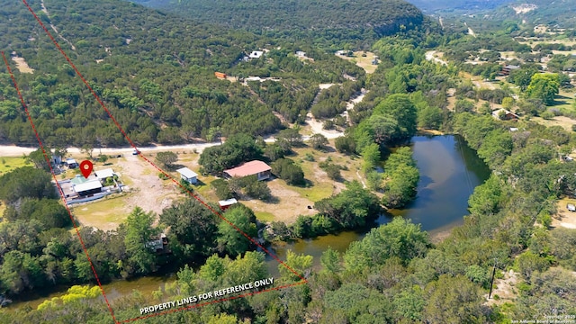 297 Bluff Creek Rd, Leakey, TX 78873 - aerial view of property's location with a forest, property boundaries highlighted, and a large body of water
