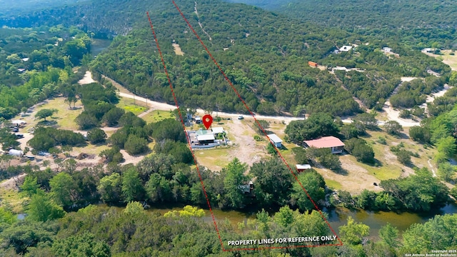297 Bluff Creek Rd, Leakey, TX 78873 - aerial view of property's location featuring a forest and property parcel outlined