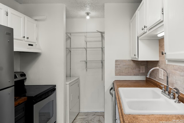 kitchen with stainless steel refrigerator, white cabinetry, sink, and electric range oven