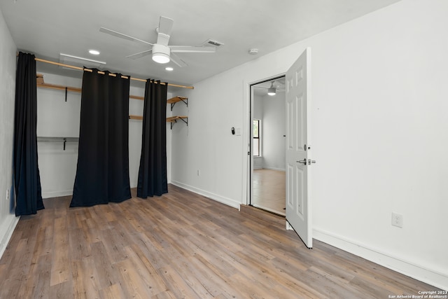 unfurnished bedroom with ceiling fan, a closet, and light wood-type flooring