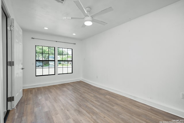 spare room featuring light wood-type flooring and ceiling fan