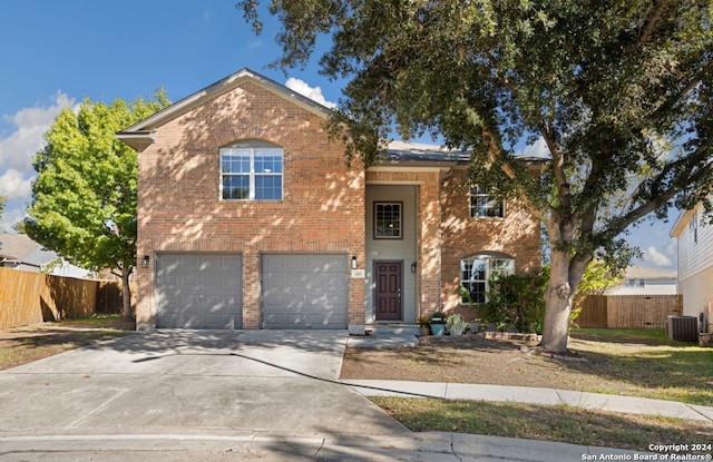 view of front of house featuring a garage and central air condition unit