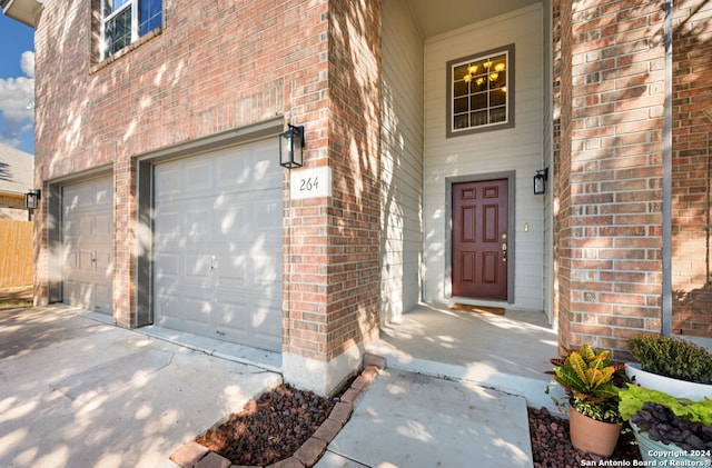 view of exterior entry featuring a garage