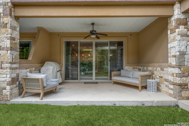 doorway to property with ceiling fan and a patio area