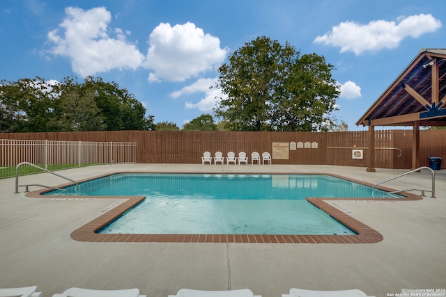 view of swimming pool with a patio area