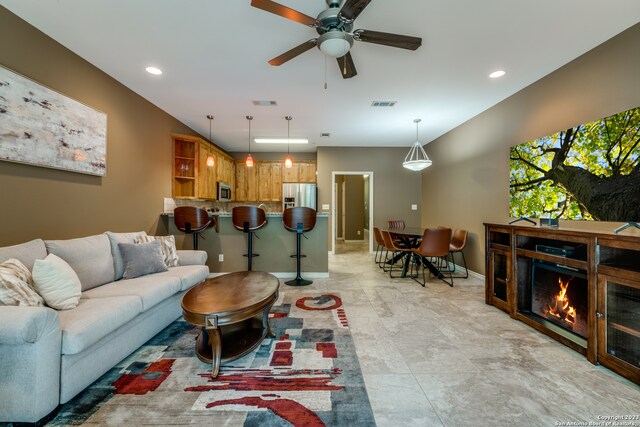 tiled living room featuring ceiling fan