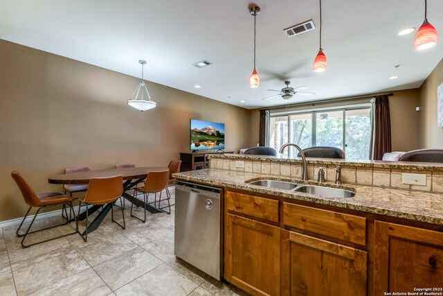 kitchen featuring pendant lighting, ceiling fan, sink, and stainless steel dishwasher