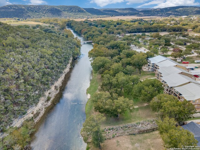 birds eye view of property featuring a water and mountain view