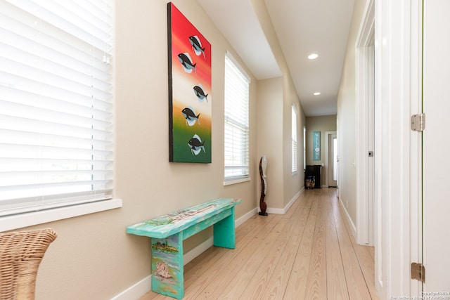 hallway with light hardwood / wood-style flooring