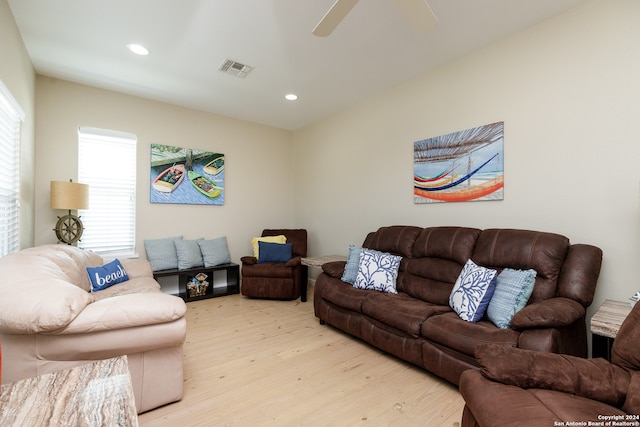 living room featuring ceiling fan and light hardwood / wood-style floors