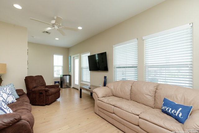 living room with light wood-type flooring and ceiling fan