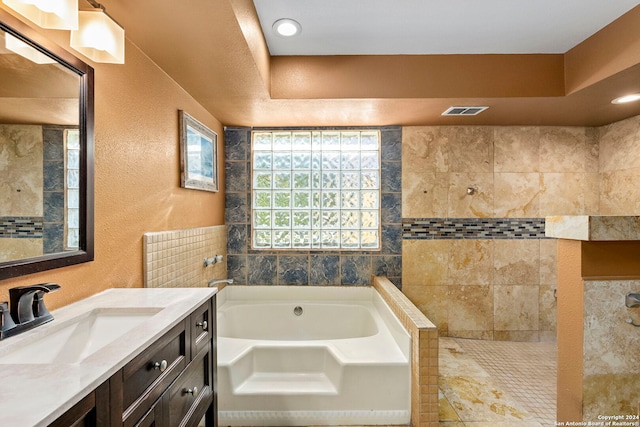 bathroom with vanity and a tub