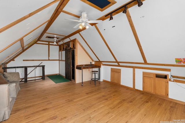 bonus room with ceiling fan, vaulted ceiling, and light wood-type flooring